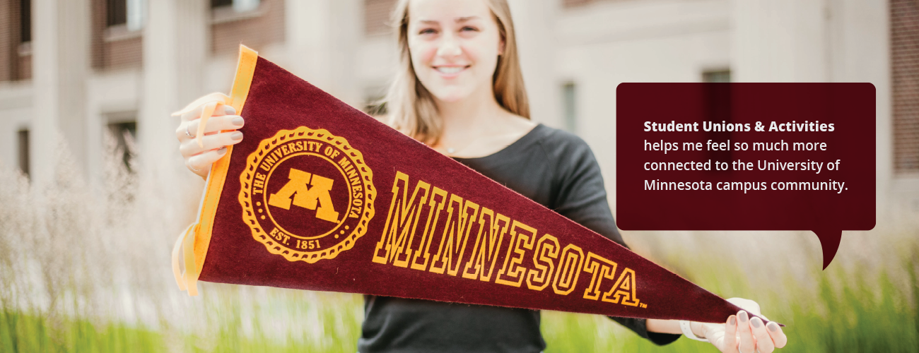 Student with a University of Minnesota pennant